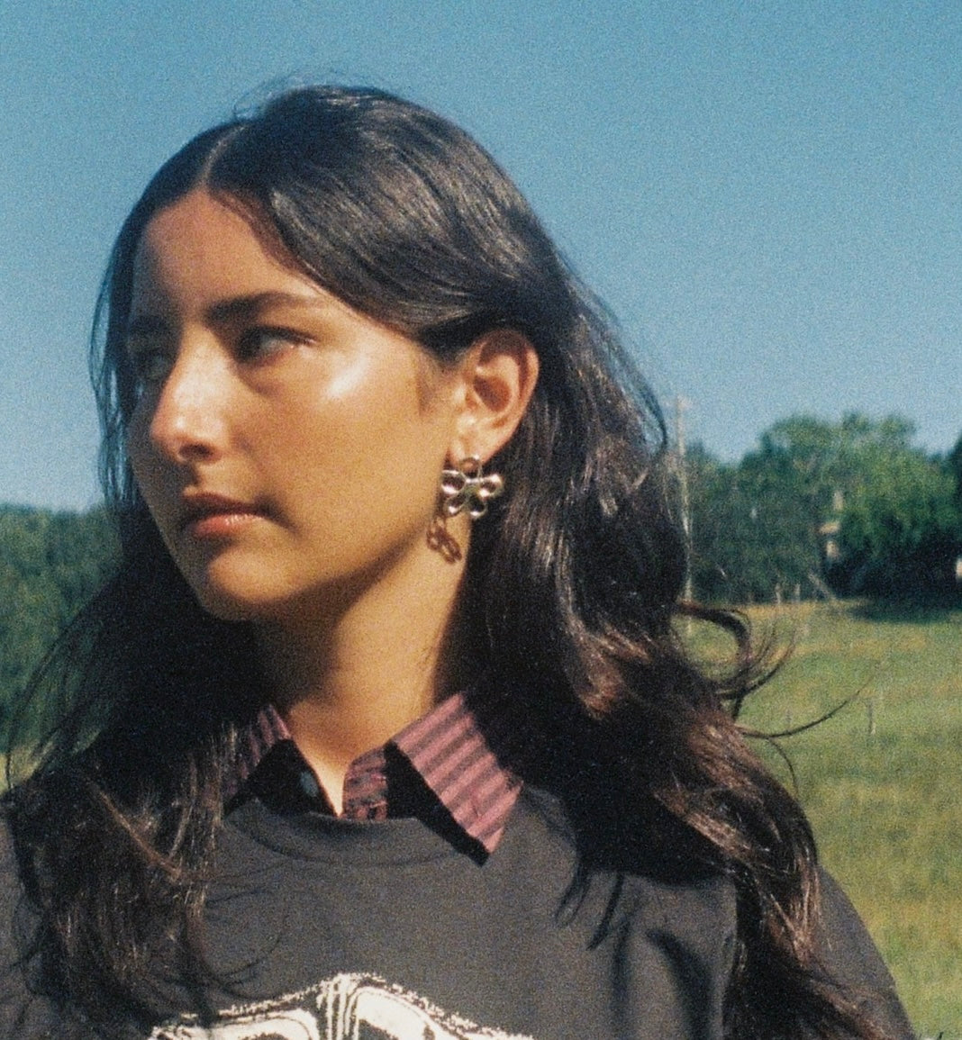 Flora stud earrings worn on model